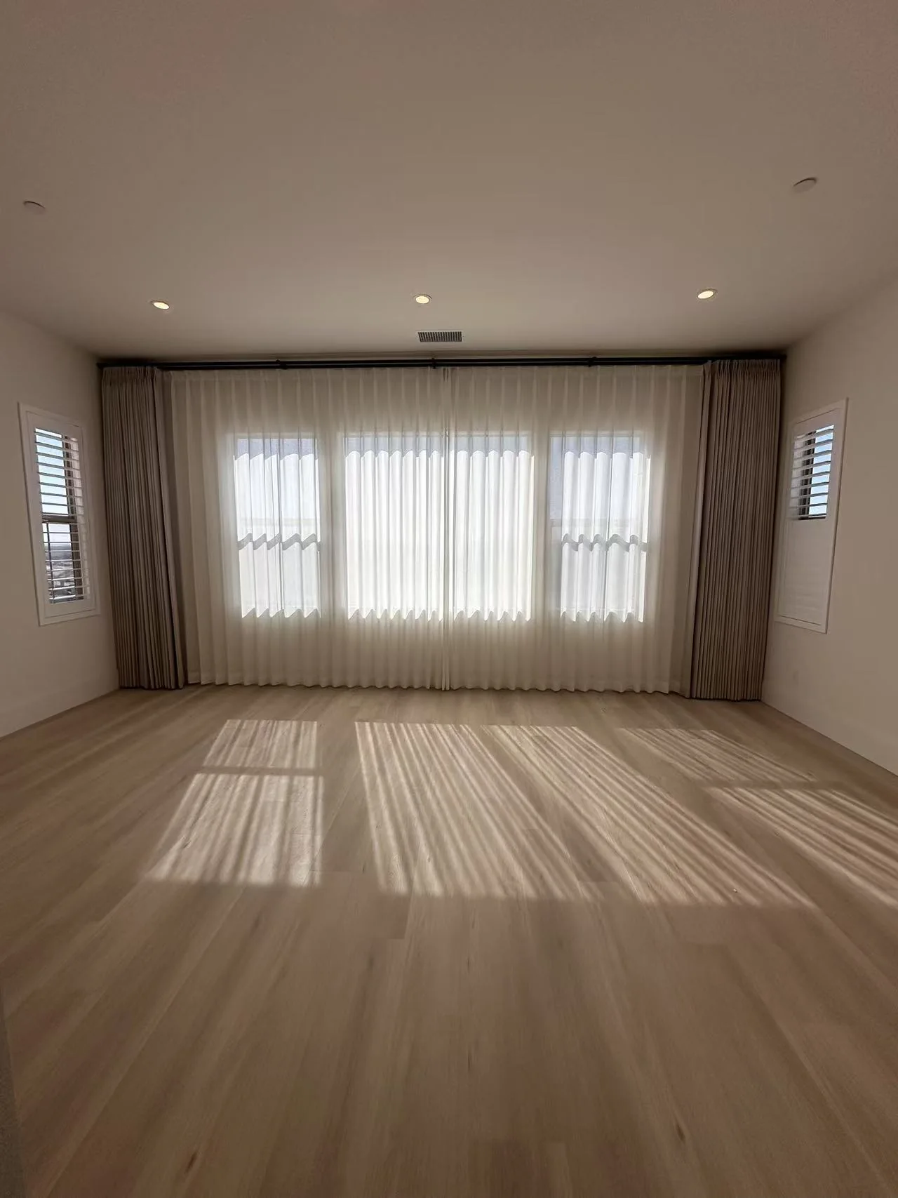 Custom drapery softly filtering daylight in a residential room