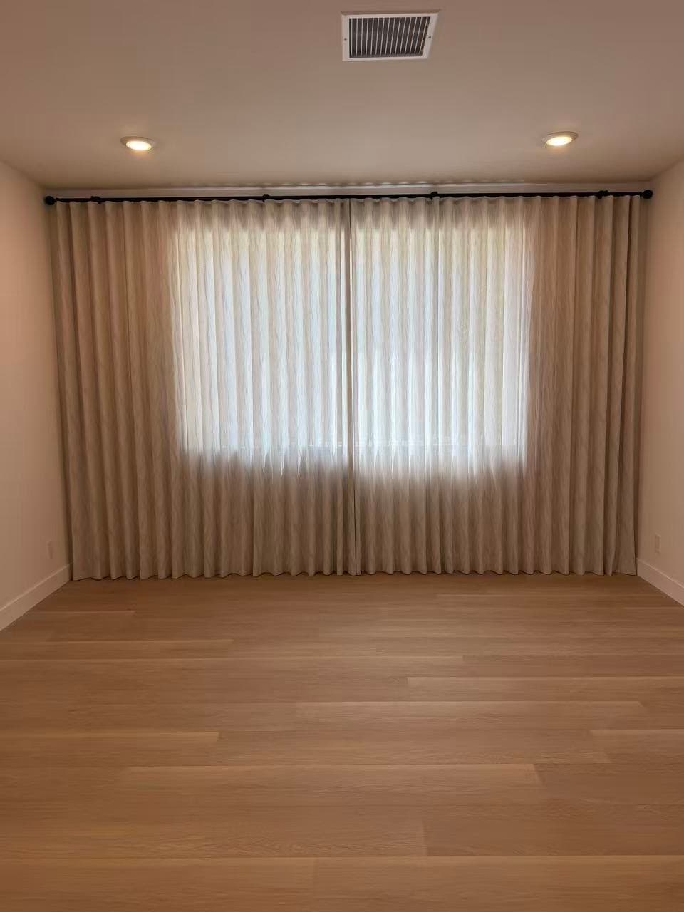 Floor-to-ceiling sheer curtains installed in a Chino living room