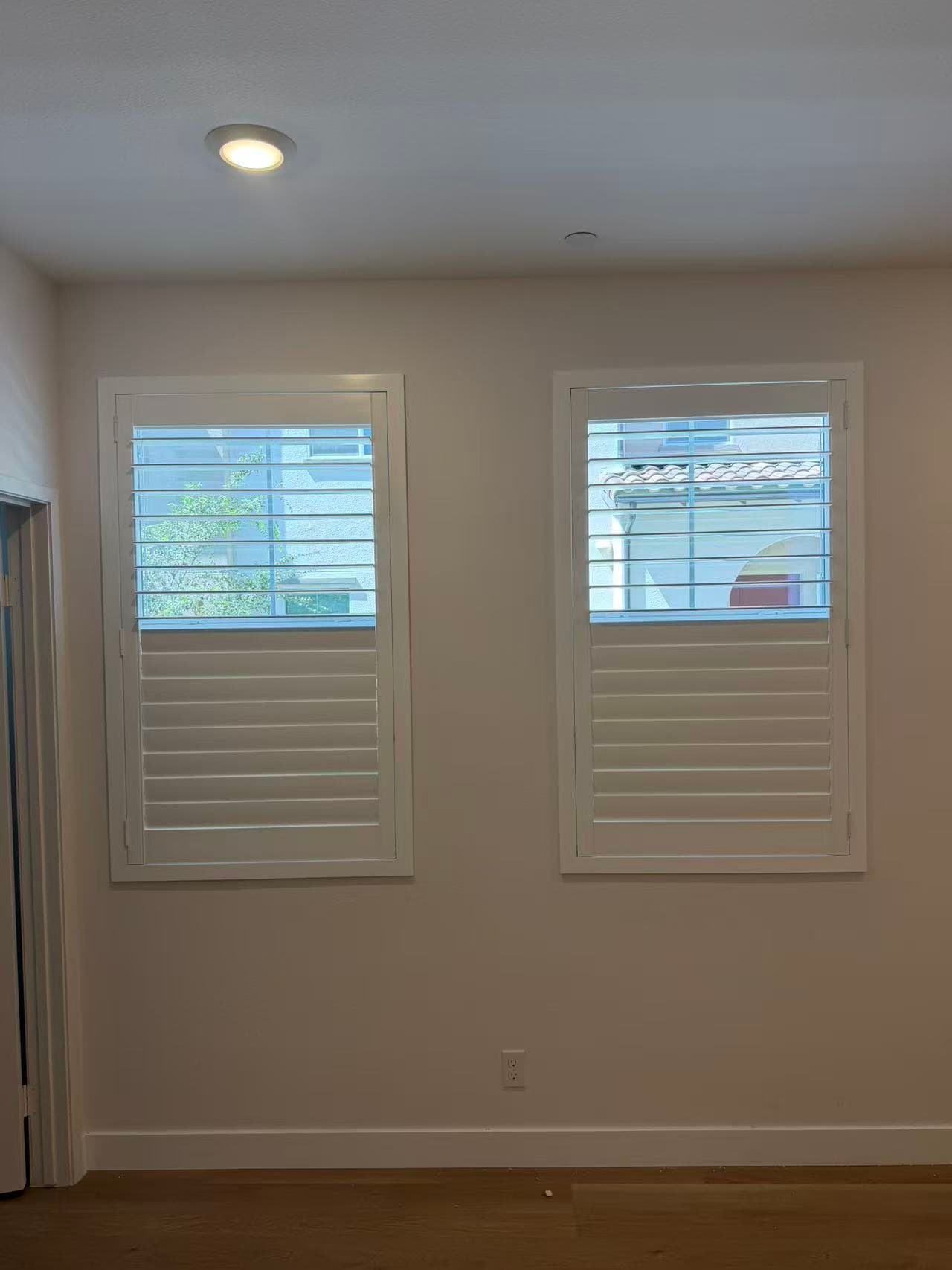 Plantation shutters installed on tall windows in a Chino residence