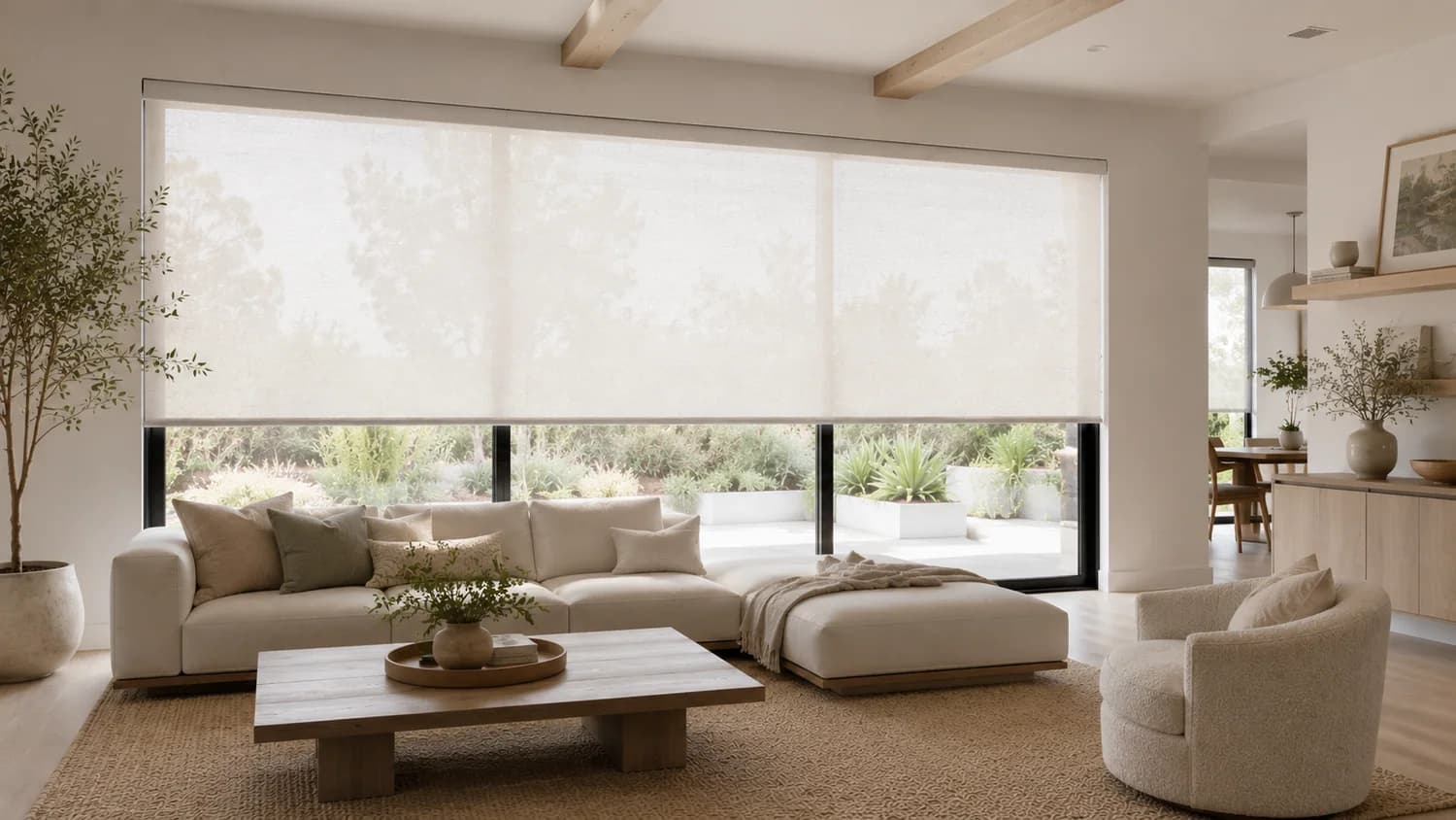 Roller shades installed across a wide living room window.