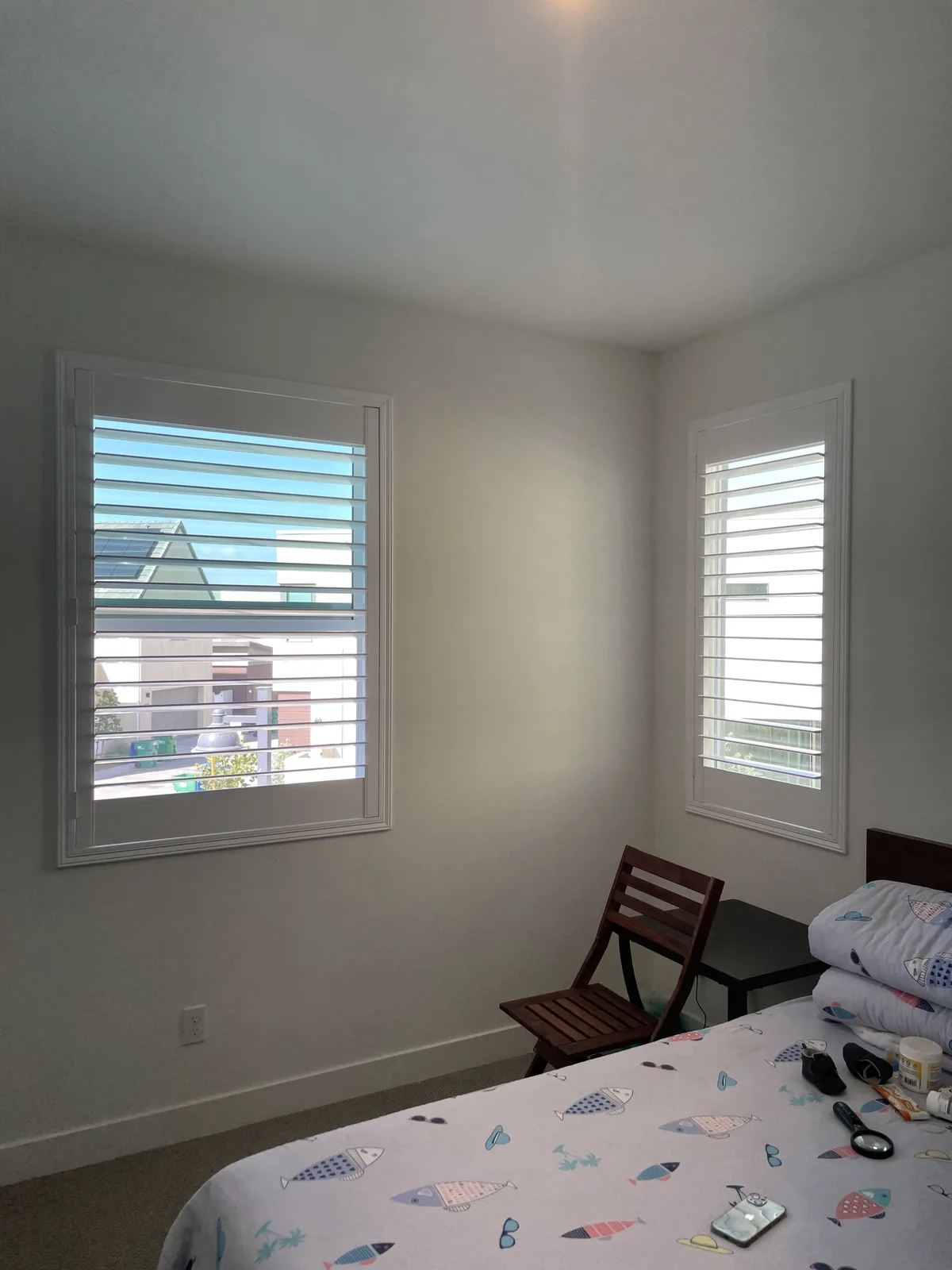 White plantation shutters on bedroom windows around a corner