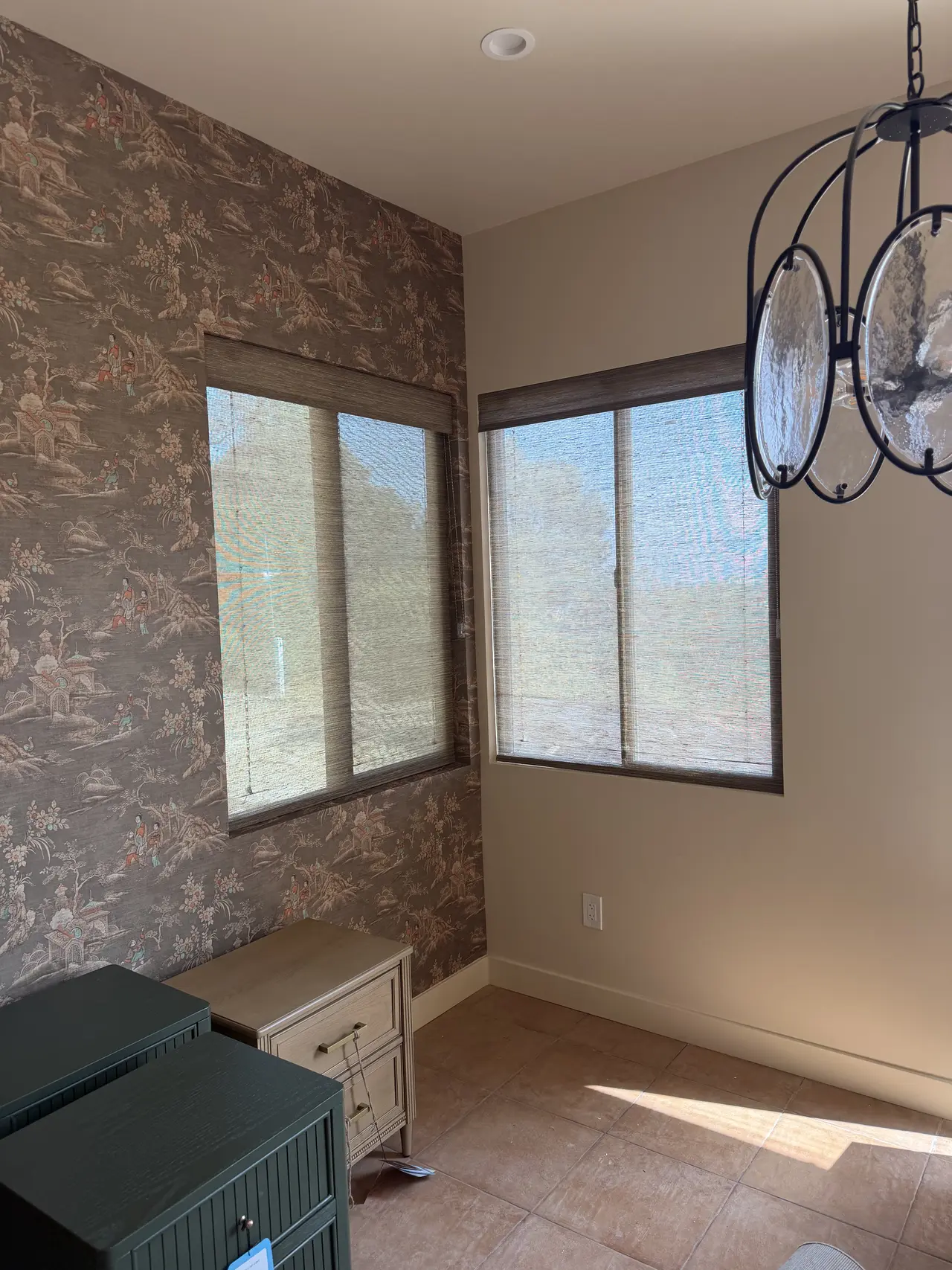 Woven wood shades installed on corner windows in a Newport Beach home