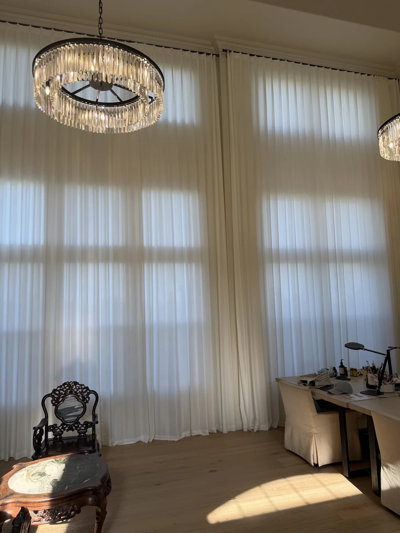 Wide interior view of sheer curtains continuing around a corner window wall in Newport Beach