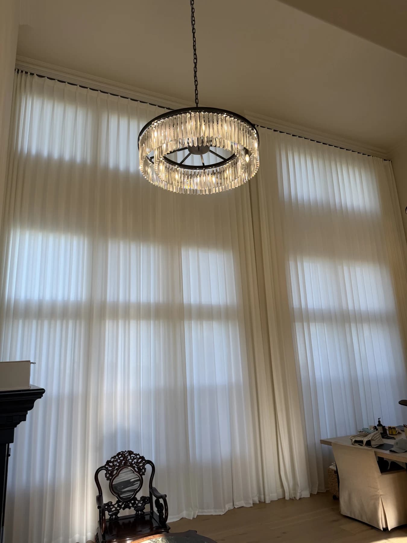 Upper and lower window sections behind full-height sheer curtains in Newport Beach